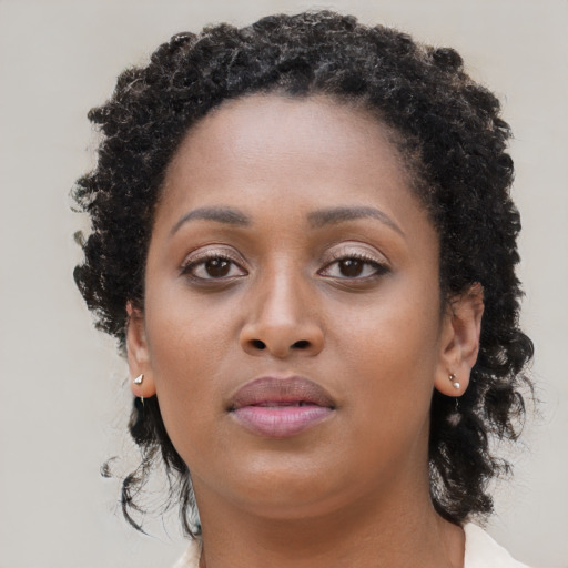 Neutral black young-adult female with long  brown hair and brown eyes