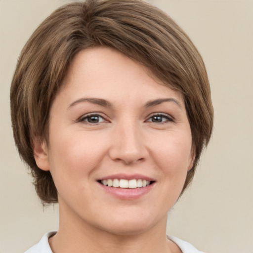 Joyful white young-adult female with medium  brown hair and green eyes