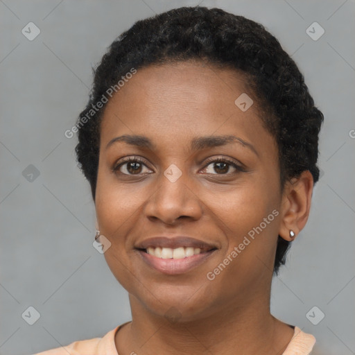 Joyful black young-adult female with short  brown hair and brown eyes