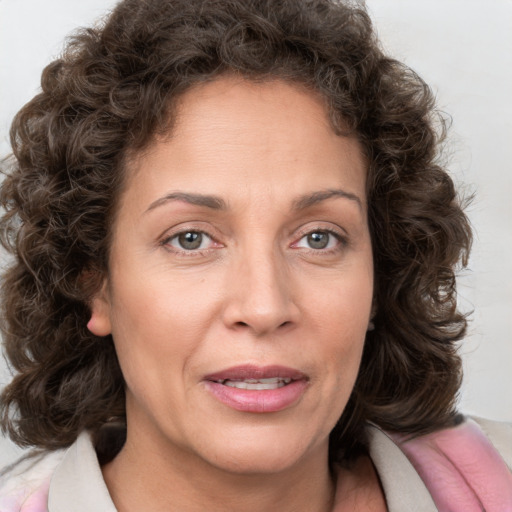 Joyful white adult female with medium  brown hair and blue eyes