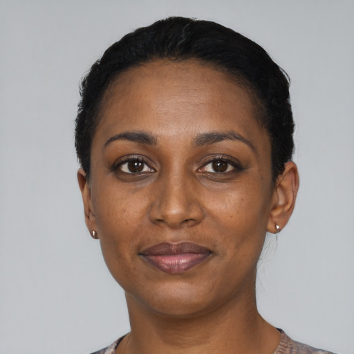 Joyful black adult female with short  black hair and brown eyes