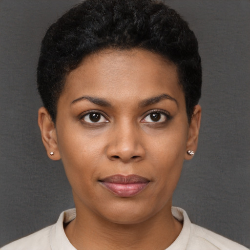 Joyful black young-adult female with short  brown hair and brown eyes