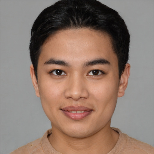 Joyful asian young-adult male with short  black hair and brown eyes