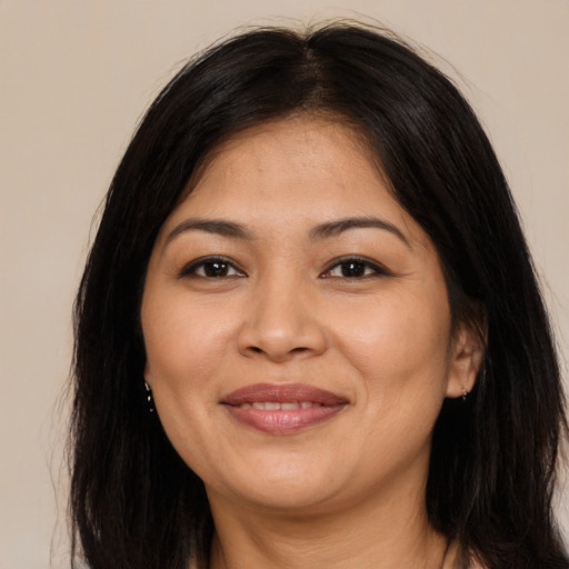 Joyful latino adult female with long  brown hair and brown eyes