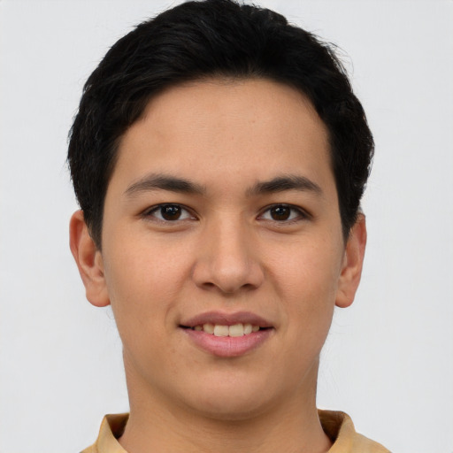 Joyful latino young-adult male with short  brown hair and brown eyes