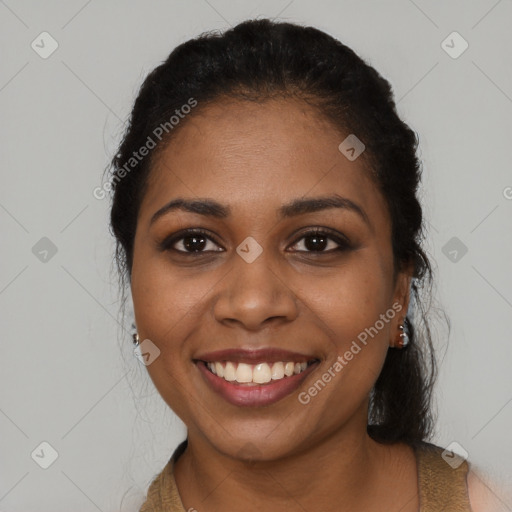 Joyful black young-adult female with long  black hair and brown eyes