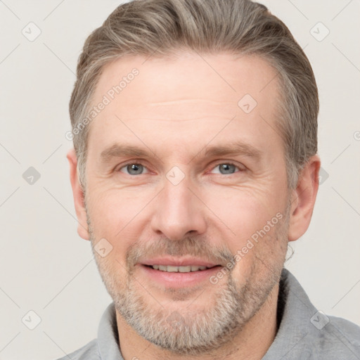 Joyful white adult male with short  brown hair and grey eyes