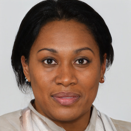 Joyful black adult female with short  black hair and brown eyes