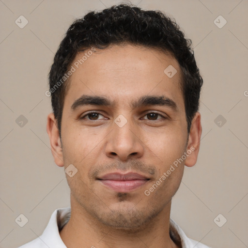 Joyful latino young-adult male with short  black hair and brown eyes