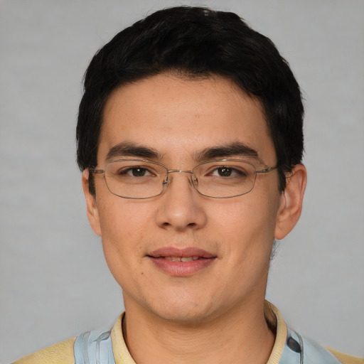 Joyful asian young-adult male with short  black hair and brown eyes