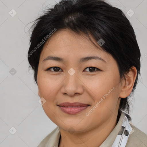 Joyful asian adult female with medium  brown hair and brown eyes