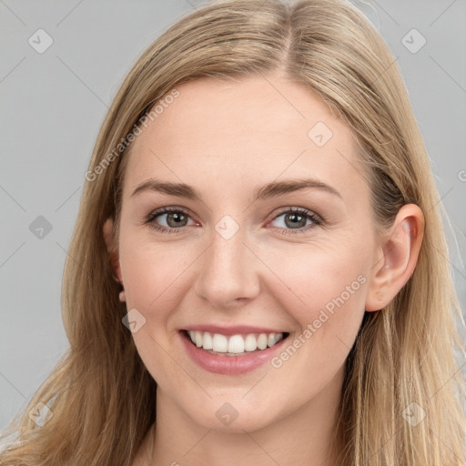 Joyful white young-adult female with long  brown hair and grey eyes