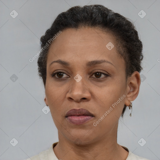 Joyful latino adult female with short  brown hair and brown eyes