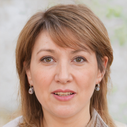 Joyful white adult female with medium  brown hair and blue eyes