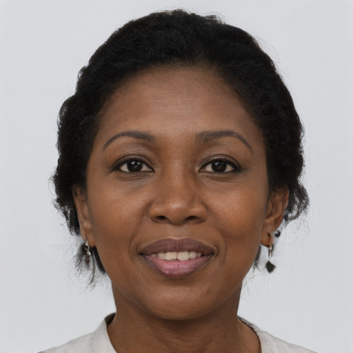 Joyful black adult female with medium  brown hair and brown eyes