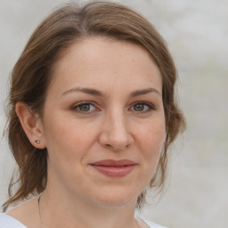 Joyful white adult female with medium  brown hair and grey eyes