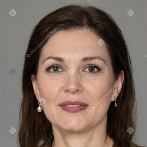 Joyful white adult female with medium  brown hair and brown eyes