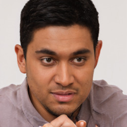 Joyful latino young-adult male with short  brown hair and brown eyes