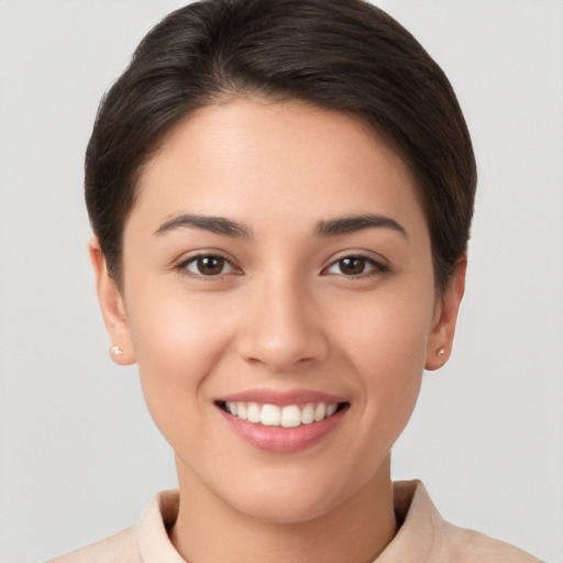 Joyful white young-adult female with short  brown hair and brown eyes