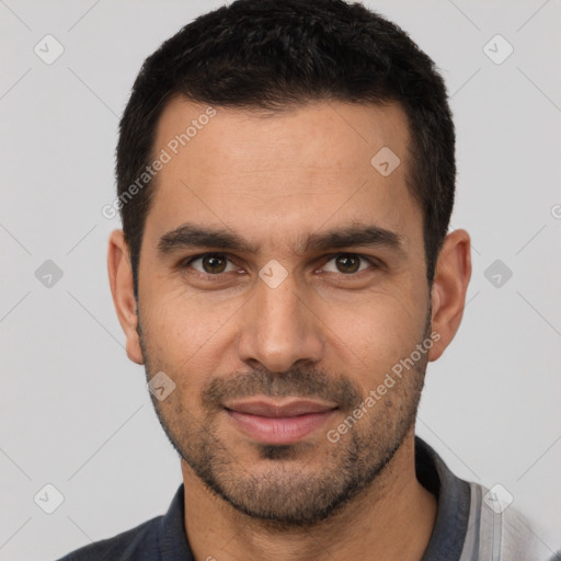 Joyful white young-adult male with short  black hair and brown eyes