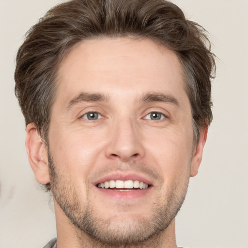 Joyful white adult male with short  brown hair and brown eyes