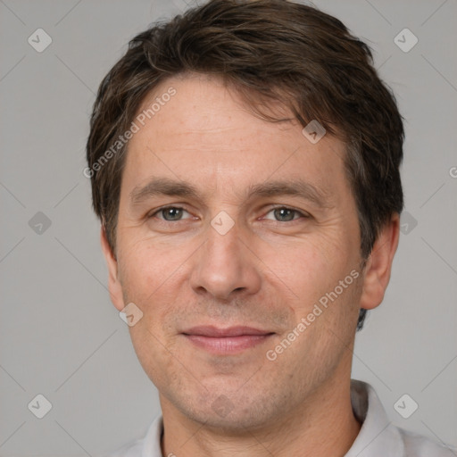 Joyful white adult male with short  brown hair and brown eyes