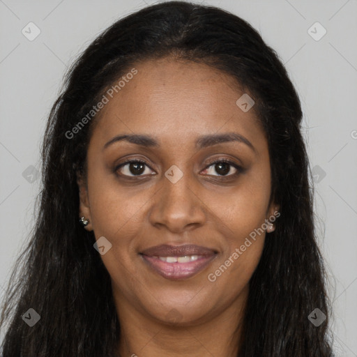 Joyful black young-adult female with long  brown hair and brown eyes