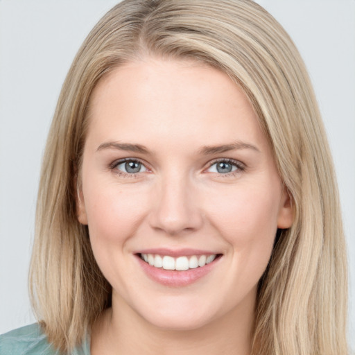 Joyful white young-adult female with long  brown hair and grey eyes