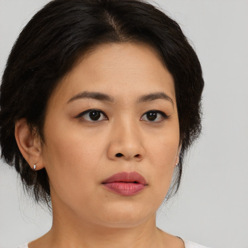 Joyful asian young-adult female with medium  brown hair and brown eyes