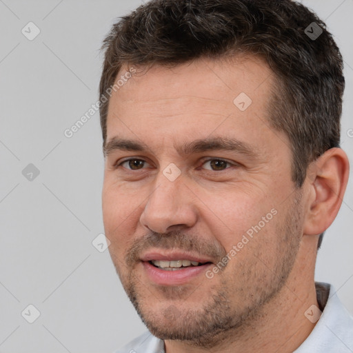 Joyful white adult male with short  brown hair and brown eyes