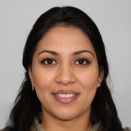 Joyful latino young-adult female with long  black hair and brown eyes
