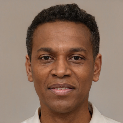 Joyful latino adult male with short  black hair and brown eyes