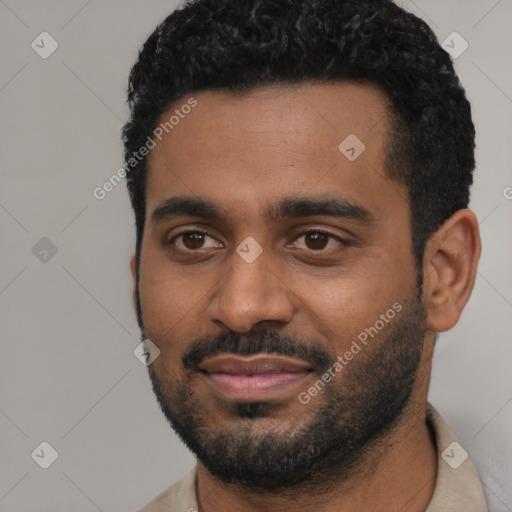 Joyful black young-adult male with short  black hair and brown eyes