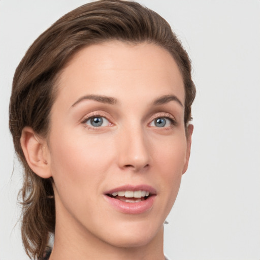 Joyful white young-adult female with medium  brown hair and grey eyes