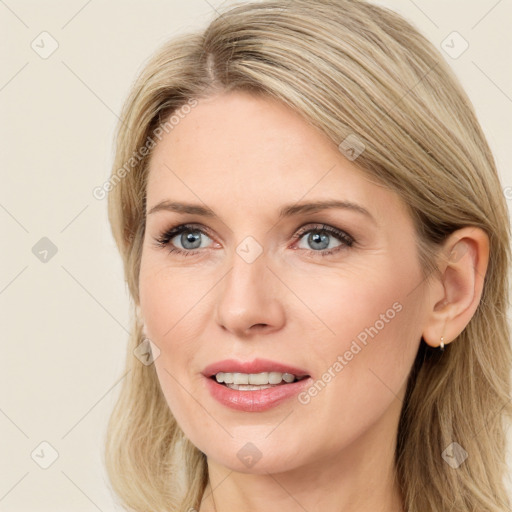 Joyful white young-adult female with long  brown hair and blue eyes