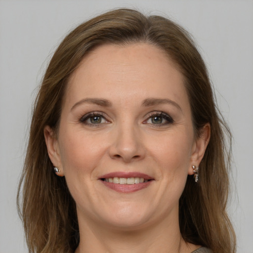 Joyful white adult female with long  brown hair and grey eyes