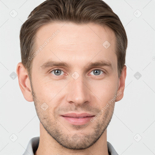 Joyful white young-adult male with short  brown hair and grey eyes