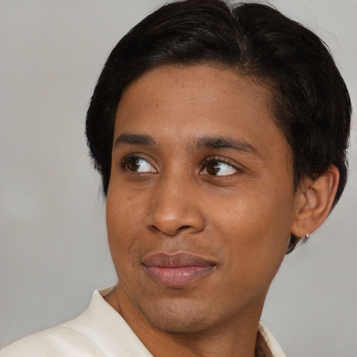 Joyful latino young-adult male with short  brown hair and brown eyes