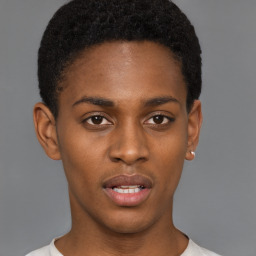 Joyful black young-adult male with short  black hair and brown eyes