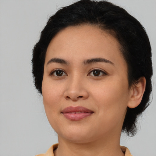 Joyful asian young-adult female with medium  black hair and brown eyes