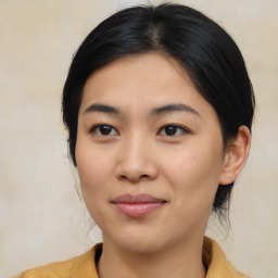 Joyful asian young-adult female with medium  black hair and brown eyes