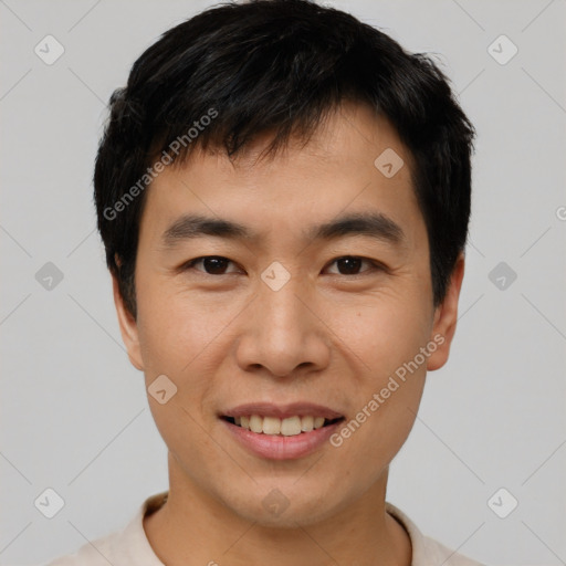 Joyful asian young-adult male with short  black hair and brown eyes