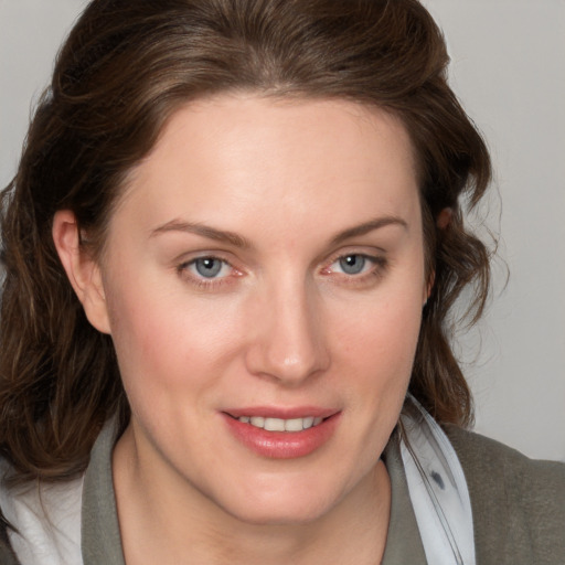 Joyful white young-adult female with medium  brown hair and blue eyes