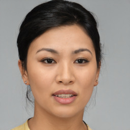 Joyful asian young-adult female with medium  brown hair and brown eyes