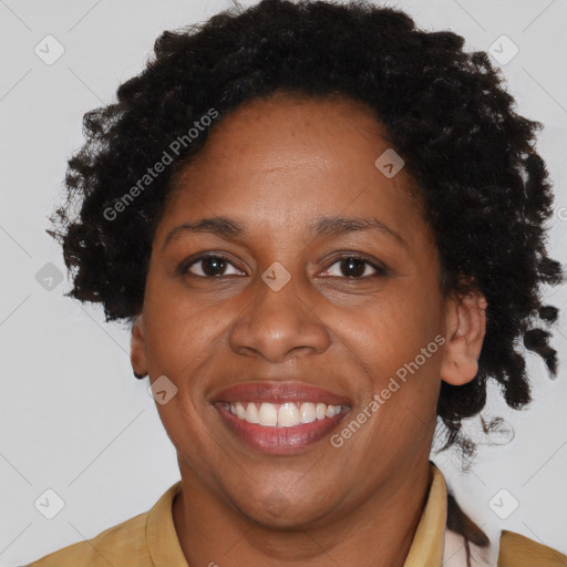 Joyful black adult female with short  brown hair and brown eyes