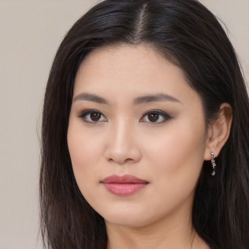 Joyful asian young-adult female with long  brown hair and brown eyes