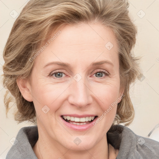 Joyful white adult female with medium  brown hair and blue eyes