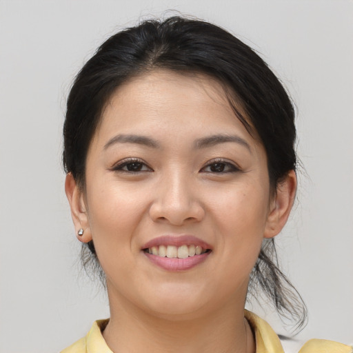 Joyful asian young-adult female with medium  brown hair and brown eyes