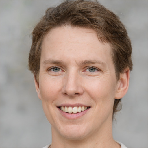 Joyful white adult female with short  brown hair and grey eyes