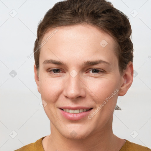 Joyful white young-adult female with short  brown hair and grey eyes